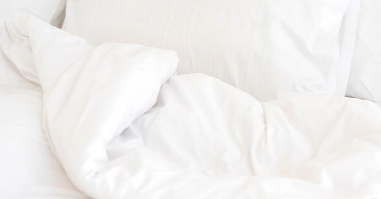 a crumpled white bed sheet