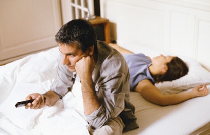 bored man in bed with wife