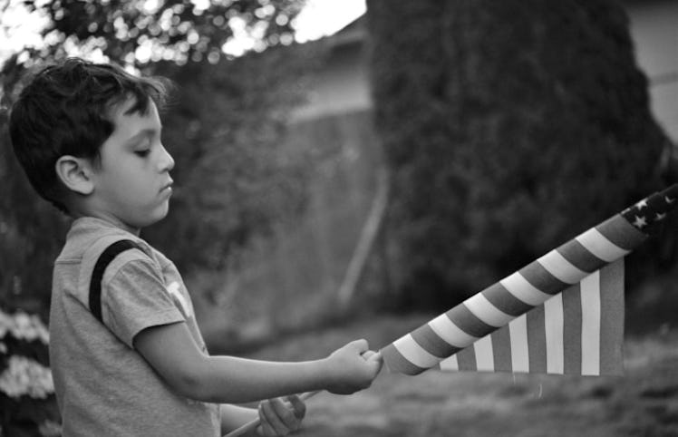 boy holding american flag