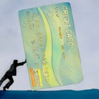 businessman pushing huge credit card