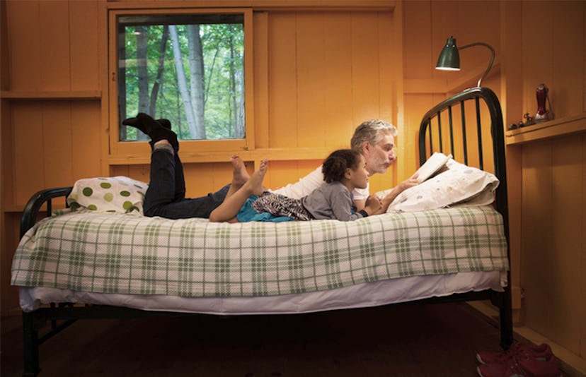 dad reading bedtime story for daughter