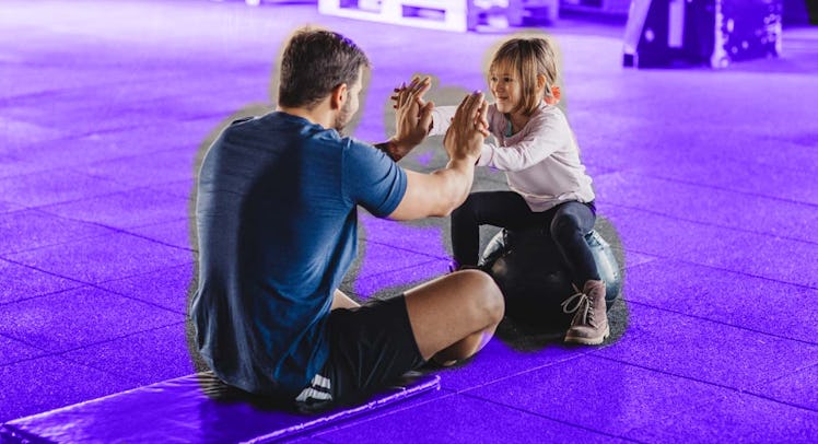 A father exercising with his daughter
