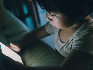 A small kid using the Internet on a mobile phone