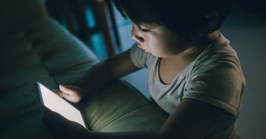 A small kid using the Internet on a mobile phone