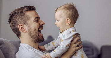 A man holding a smiling baby.