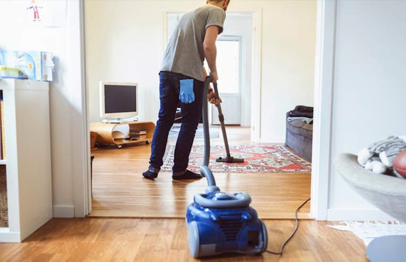 man vaccuuming floor