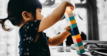 A child learning how to put building blocks together before kindergarten