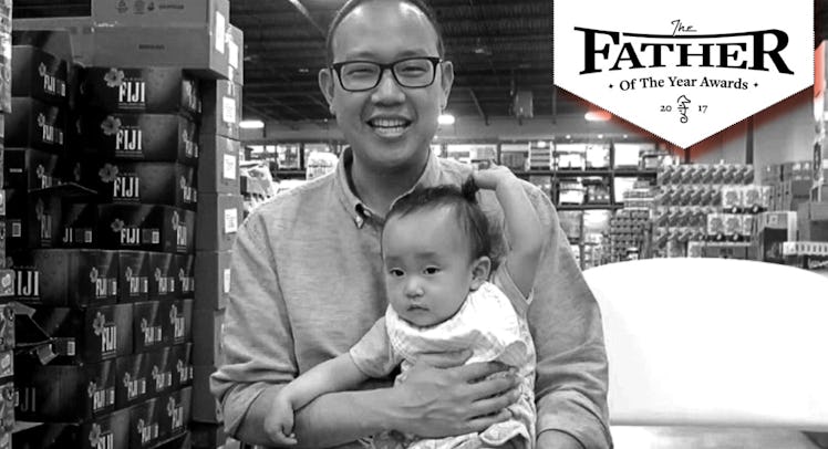 Chieh Huang holding his child with a "Father of the Year" sign above him