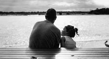 greyscale edit of a dad and daughter submerged in a pool
