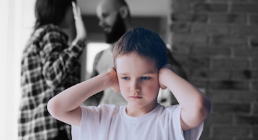 child covering ears parents fight about divorce