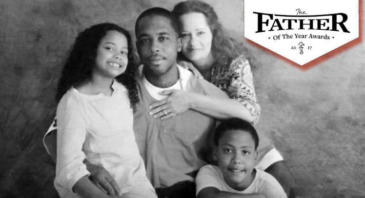 A father posing for a photo with his wife, son, and daughter and the text 'Father of the year'