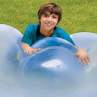 A young boy leaned on a Wubble Bubble