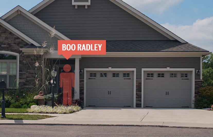 A house in the suburbs with a red coutout of a man and a sign saying boo radley