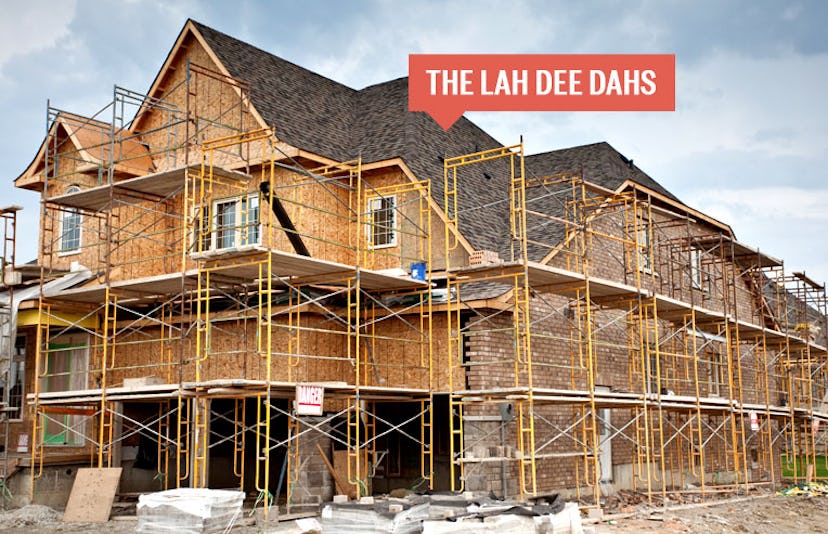 A big house under construction with a sign that reads The Lah Dee Dahs