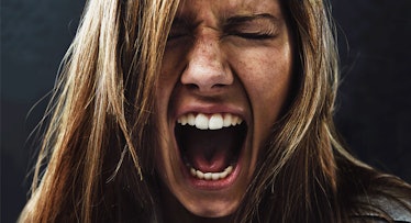 close up head shot of a woman screaming