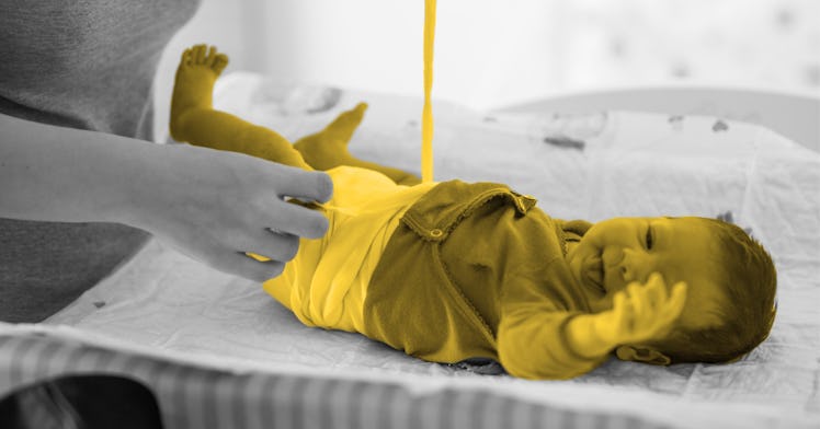 black and white edit of a baby on a diaper changing table being changed by a parent