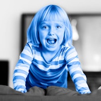 blue photo edit of a girl standing on a sofa next to her sibling