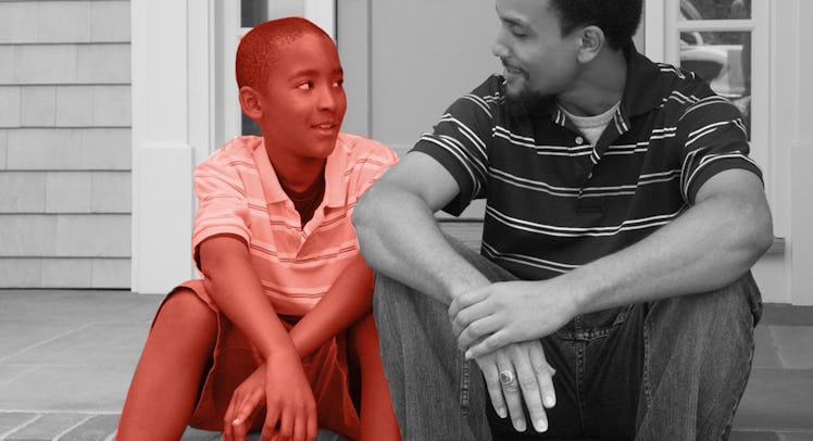 A father talking with his son in front of their house