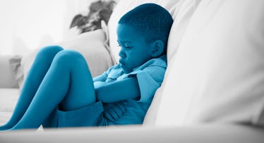 boy sulking laying on a bed