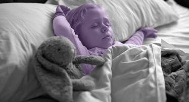 a baby in a purple edit sleeps with a stuffed animal and a blanket