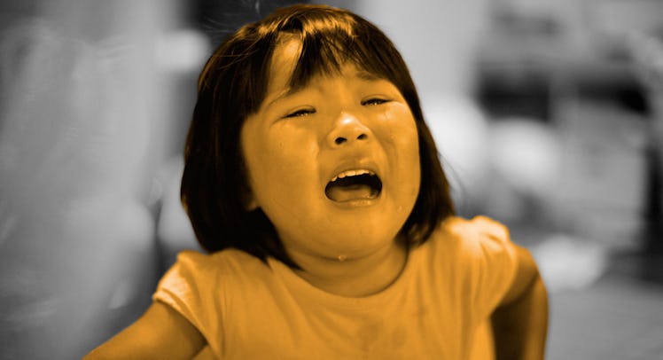 A crying toddler girl whose parents need to know how to discipline her with a yellow and grey color ...