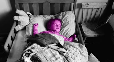 grey scale edit of a child sleeping in a toddler bed