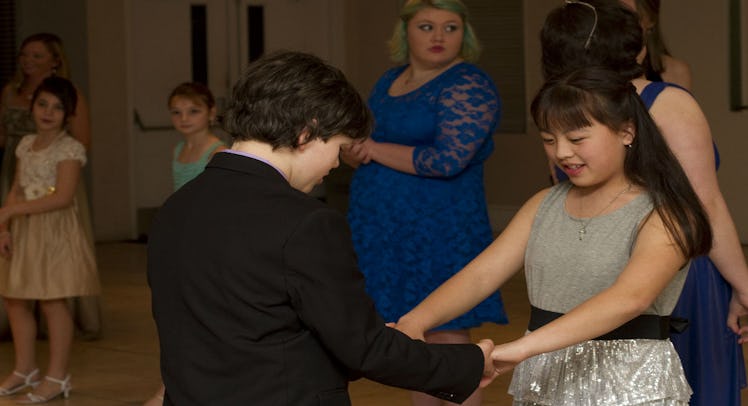 Two sixth-grade elementary school students dancing at the Utah School's Valentine's Day event