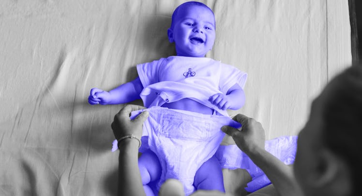 A mother changing her baby's standard baby diaper.