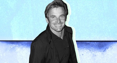 Laird Hamilton wearing a jacket and black shirt in front of a two tone blue background