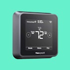The Honeywell T5+ Smart Thermostat, which is one of the best smart thermostats with a green backgrou...