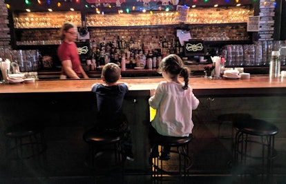 Two kid sitting at the bar in the Rock and Roll Playhouse