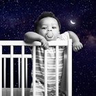 baby standing in cot. 4 month sleep regression