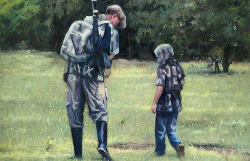 A dad and his son at an outdoor shooting range with guns and hunting equipment