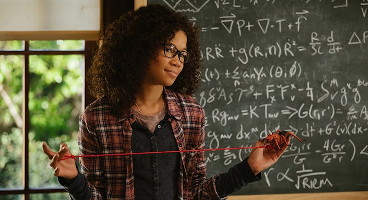 Storm Reid standing in front of a black board explaining the tesseract in A Wrinkle in Time