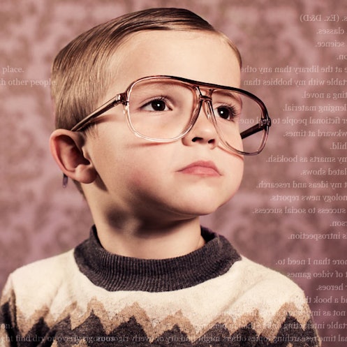 A nerdy child in glasses and a sweater.