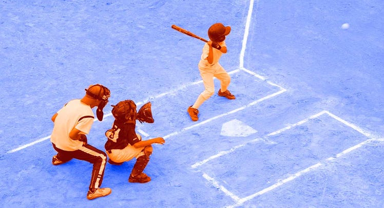 A group of kids playing little league baseball on the field