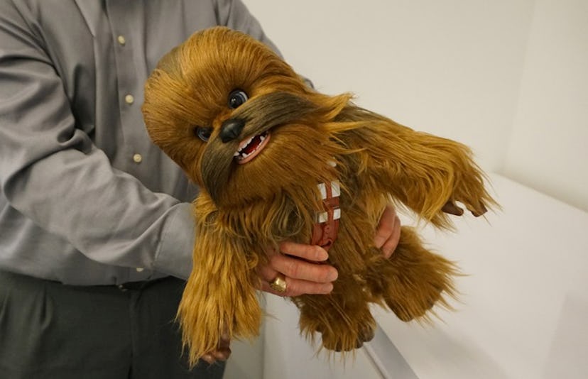 A man holding the Star Wars Ultimate Co-Pilot Chewie