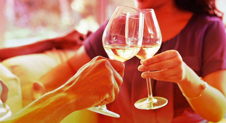close up shot of a couple clinking wine glasses