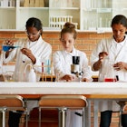 Young Students Wearing Lab Coats
