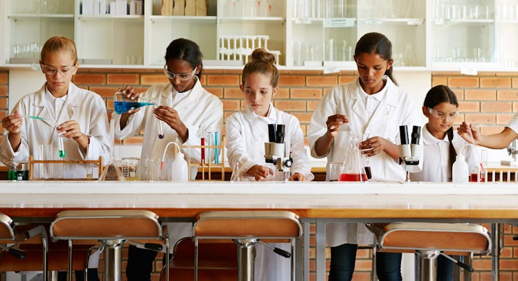 Young students wearing lab coats