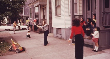 Children playing ball in front of their homes on Neptune Road 