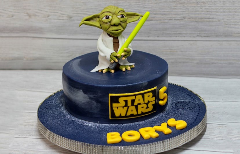 A blue Star Wars cartoon cake for a fifth birthday