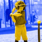 A little boy playing tee-ball