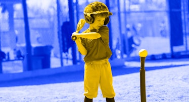 A little boy playing tee-ball