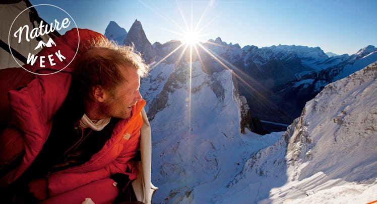 Conrad Anker looking out of his tent in the middle of a mountain site