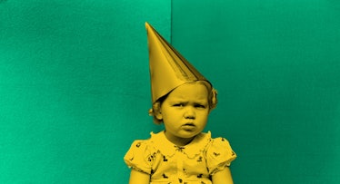 On a green background, a yellow-colored child wearing a birthday hat