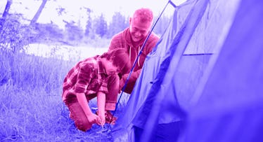 A father teaching a Kid to Pitch a Tent