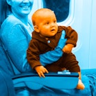 blue and pink photo edit of a happy mother seated on an airplane flying with a baby