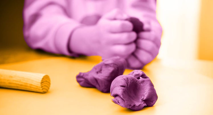 Child's hands playing with homemade playdough.
