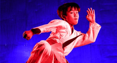 A boy in movement who is practicing martial arts for self-defense with a red and blue color filter